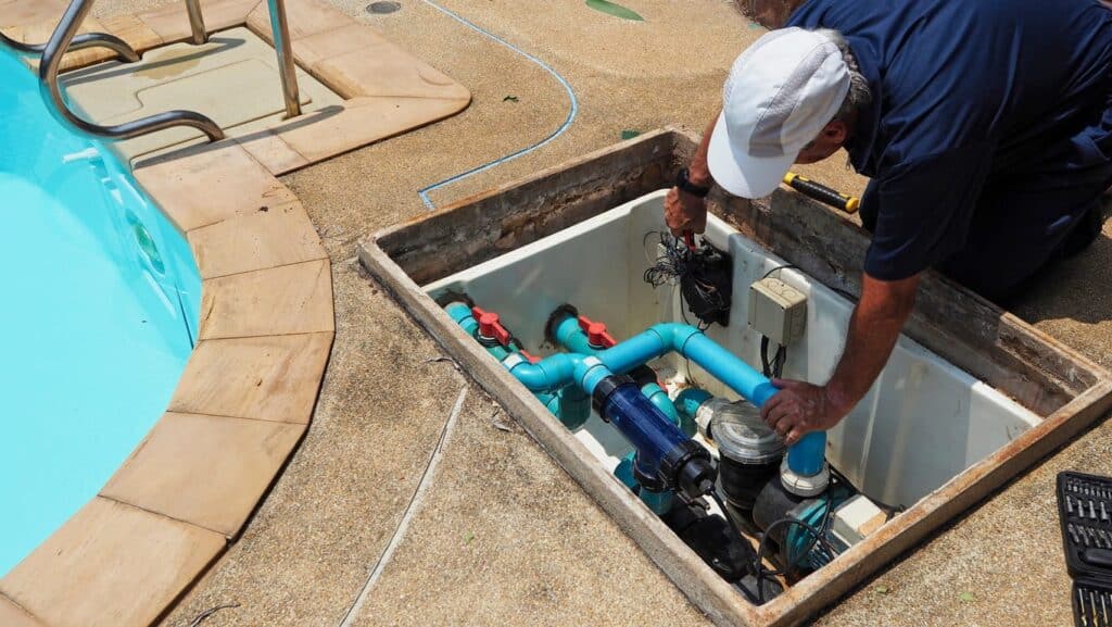 A Las Vegas plumber working on an inground pool. 